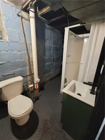 a white toilet sitting next to a bathroom sink