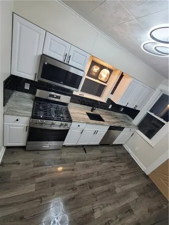 a kitchen with stove and cabinets