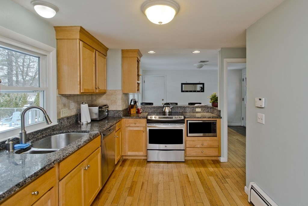 128 Birch Road Longmeadow, MA 01106 - Photo 15 of 39 a kitchen with stainless steel appliances granite countertop a sink a stove top oven a counter space and cabinets