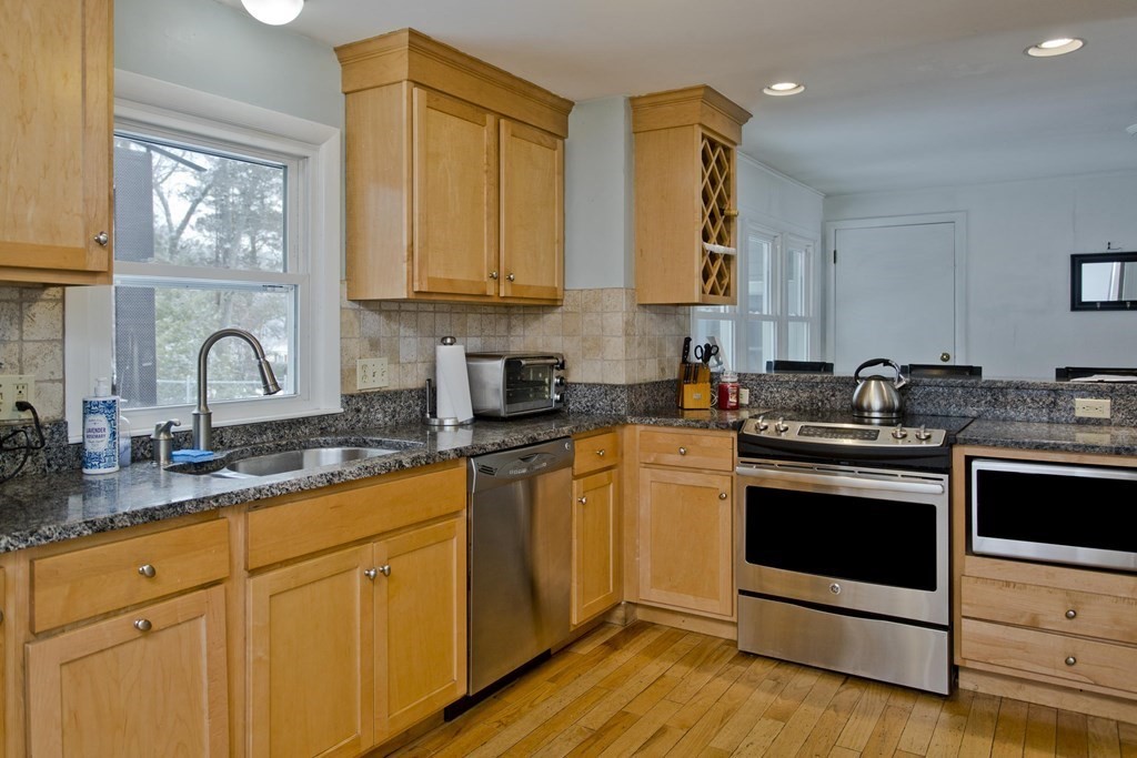 128 Birch Road Longmeadow, MA 01106 - Photo 16 of 39 a kitchen with stainless steel appliances granite countertop a stove sink and cabinets