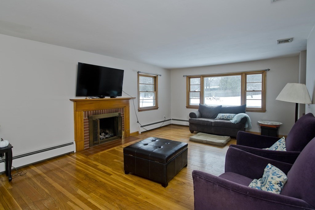 128 Birch Road Longmeadow, MA 01106 - Photo 17 of 39 a living room with furniture a flat screen tv and a fireplace