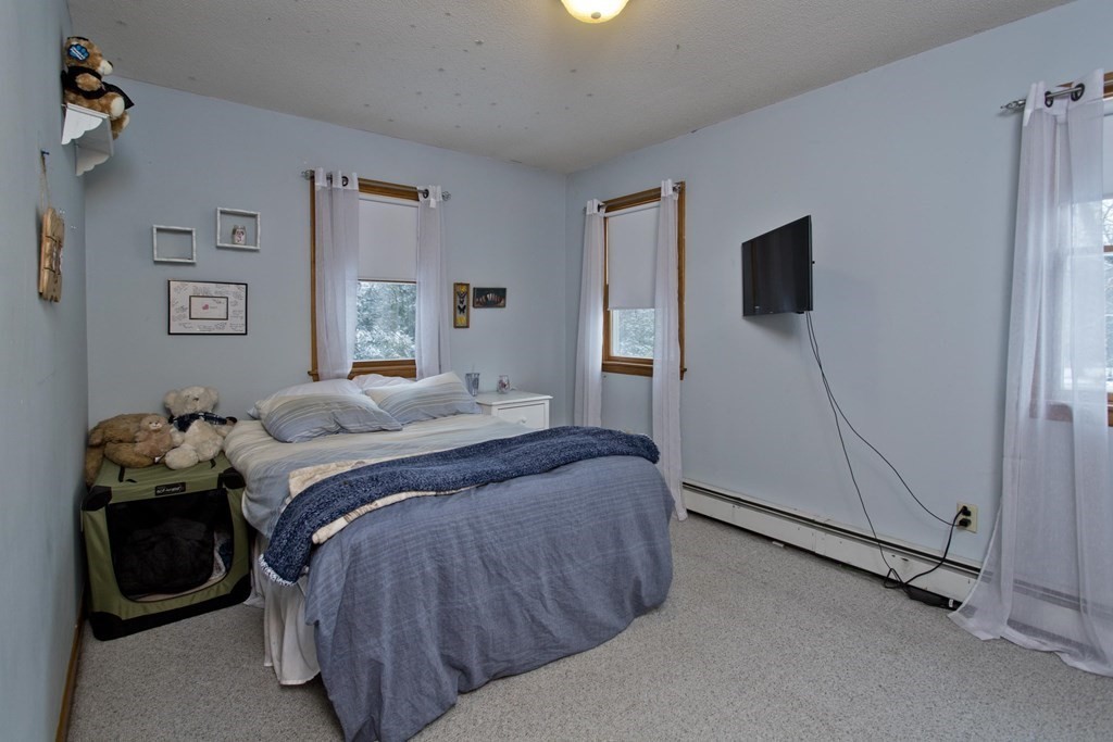 128 Birch Road Longmeadow, MA 01106 - Photo 25 of 39 a bedroom with a bed and a flat screen tv