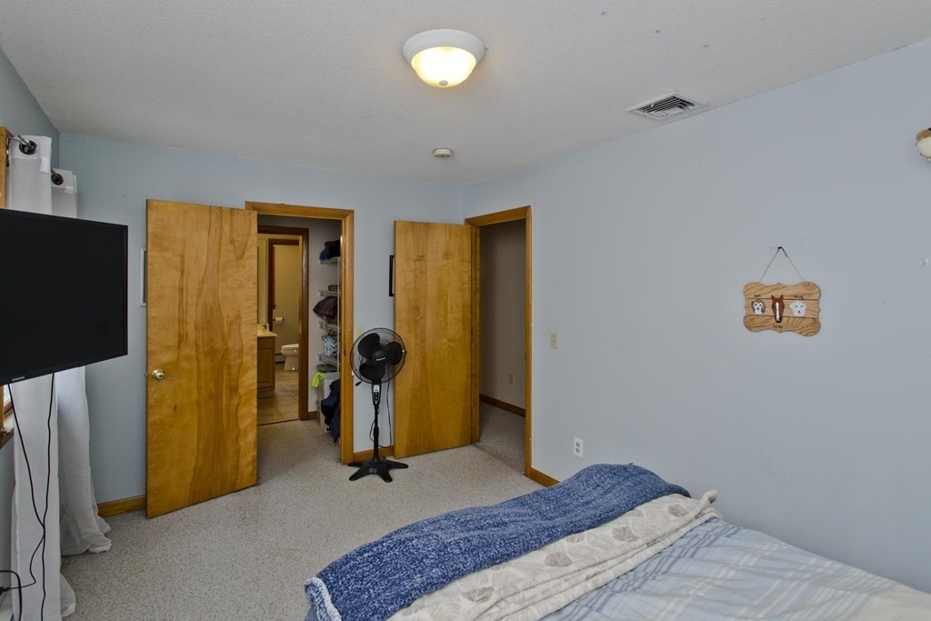 128 Birch Road Longmeadow, MA 01106 - Photo 26 of 39 a bedroom with a bed and a mirror