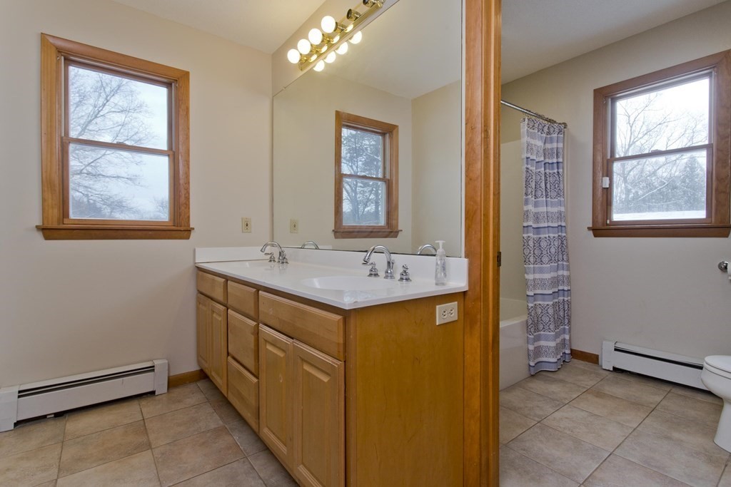 128 Birch Road Longmeadow, MA 01106 - Photo 27 of 39 a bathroom with a granite countertop sink a mirror and a shower
