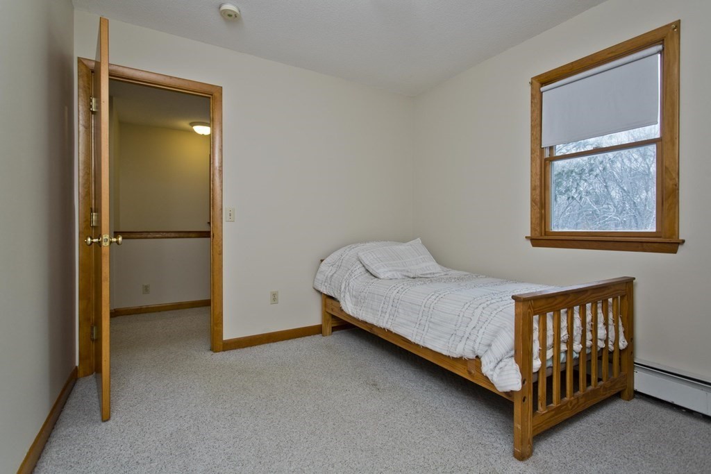 128 Birch Road Longmeadow, MA 01106 - Photo 31 of 39 a bed sitting in a room next to a window