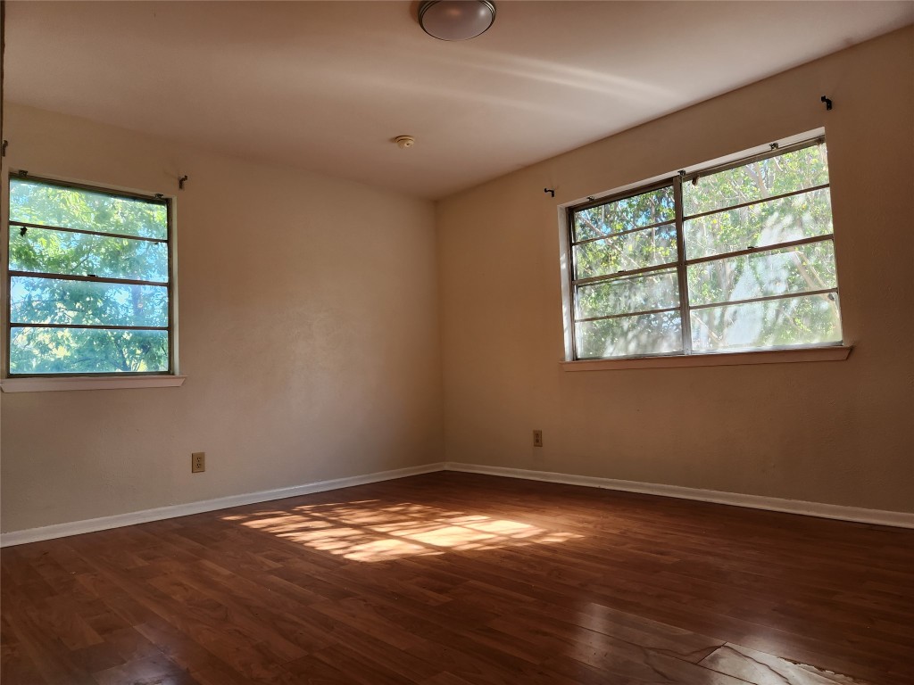 Undisclosed Address Austin, TX 78758 - Photo 12 of 21 an empty room with wooden floor and windows