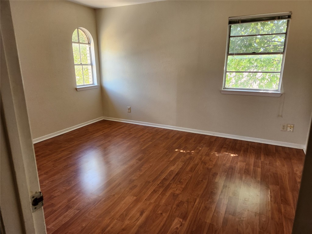 Undisclosed Address Austin, TX 78758 - Photo 14 of 21 an empty room with wooden floor and windows