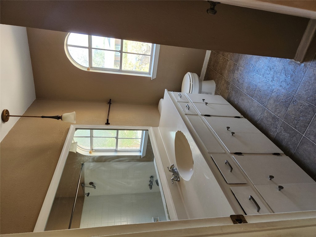 Undisclosed Address Austin, TX 78758 - Photo 15 of 21 a bath room with a sink a toilet and a window