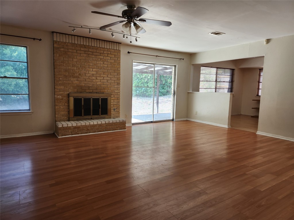 Undisclosed Address Austin, TX 78758 - Photo 3 of 21 a view of an empty room with wooden floor and a window