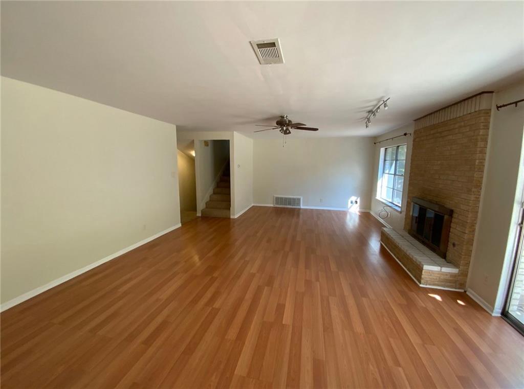 Undisclosed Address Austin, TX 78758 - Photo 4 of 21 a view of empty room with wooden floor and fireplace