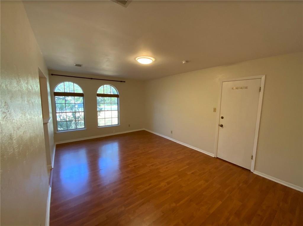 Undisclosed Address Austin, TX 78758 - Photo 8 of 21 an empty room with wooden floor and windows