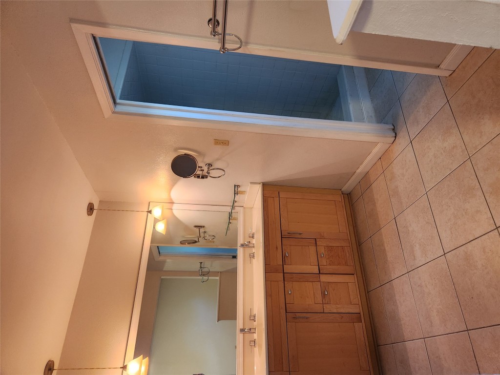 Undisclosed Address Austin, TX 78758 - Photo 10 of 21 a bathroom with a sink a mirror and a shower