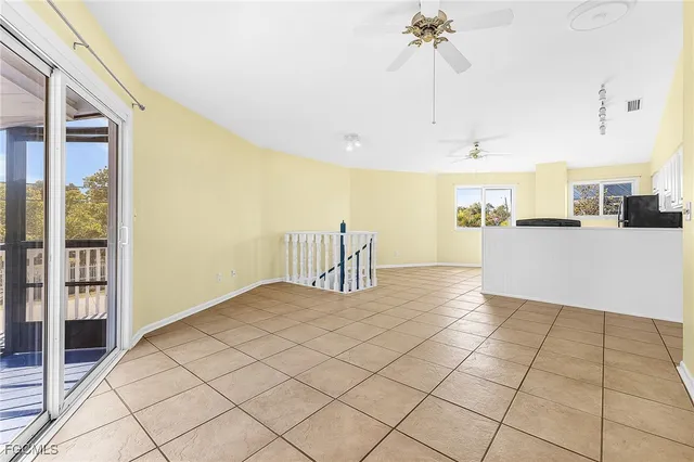 a view of a kitchen with furniture and a chandelier fan