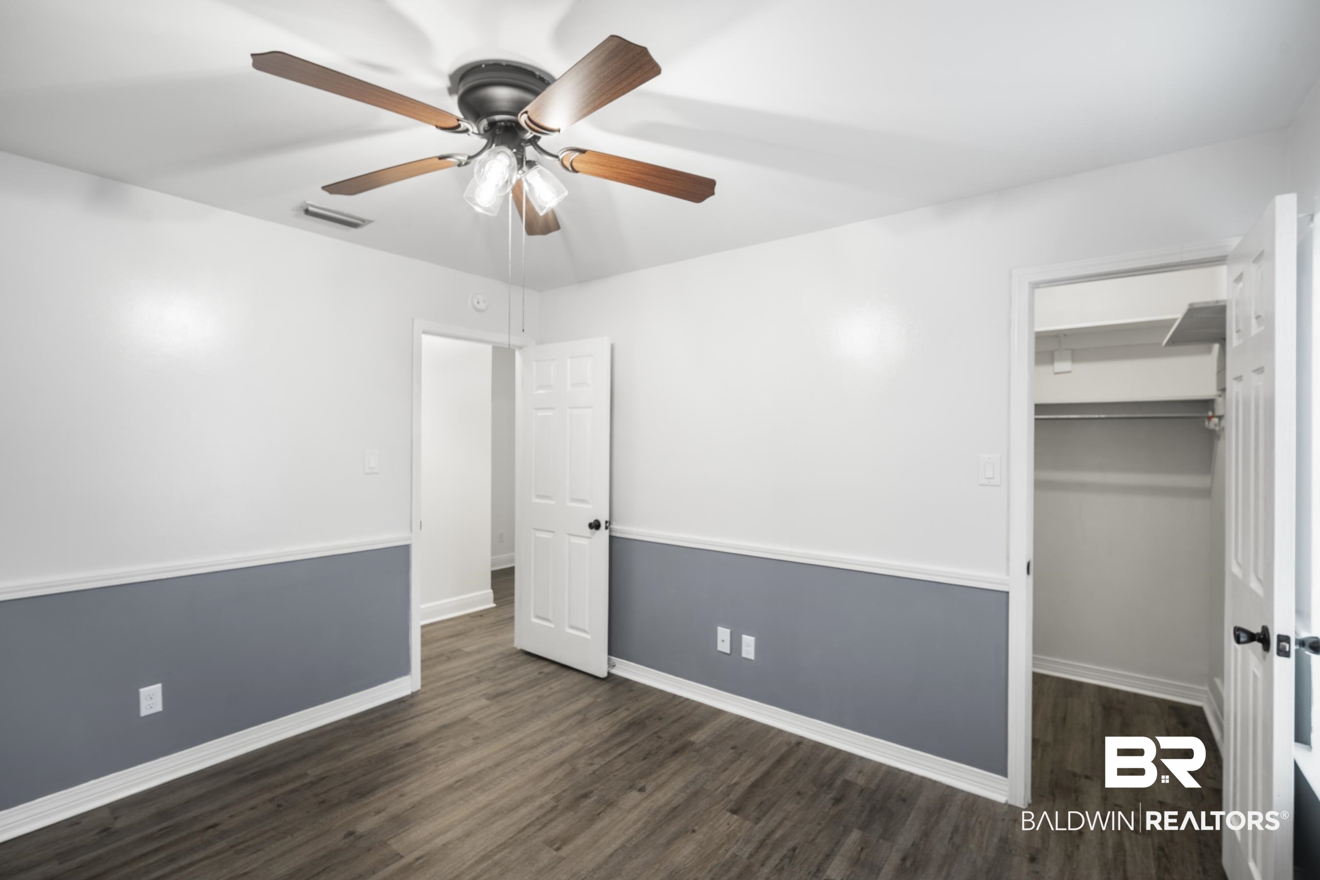3101 Autumn Ridge Drive West Mobile, AL 36695 - Photo 22 of 36 Unfurnished bedroom with a walk in closet, dark wood finished floors, and ceiling fan