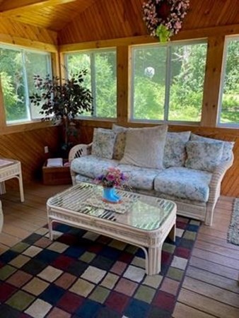 47 South Road Londonderry, NH 03053 - Photo 23 of 39 a living room with a couch a large window and a table