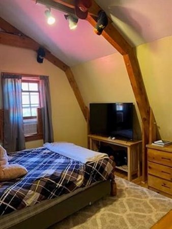 47 South Road Londonderry, NH 03053 - Photo 27 of 39 a bedroom with a bed and a flat screen tv