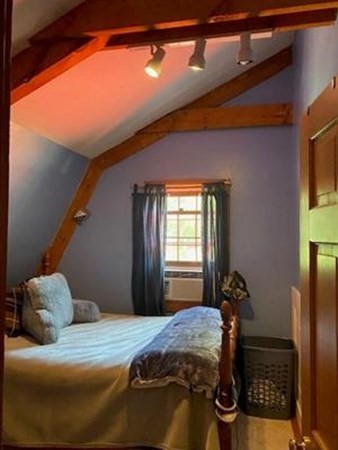 47 South Road Londonderry, NH 03053 - Photo 29 of 39 a bedroom with a bed and wooden floor