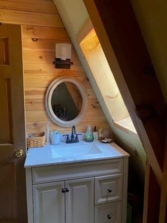 47 South Road Londonderry, NH 03053 - Photo 34 of 39 a bathroom with a sink a mirror and vanity