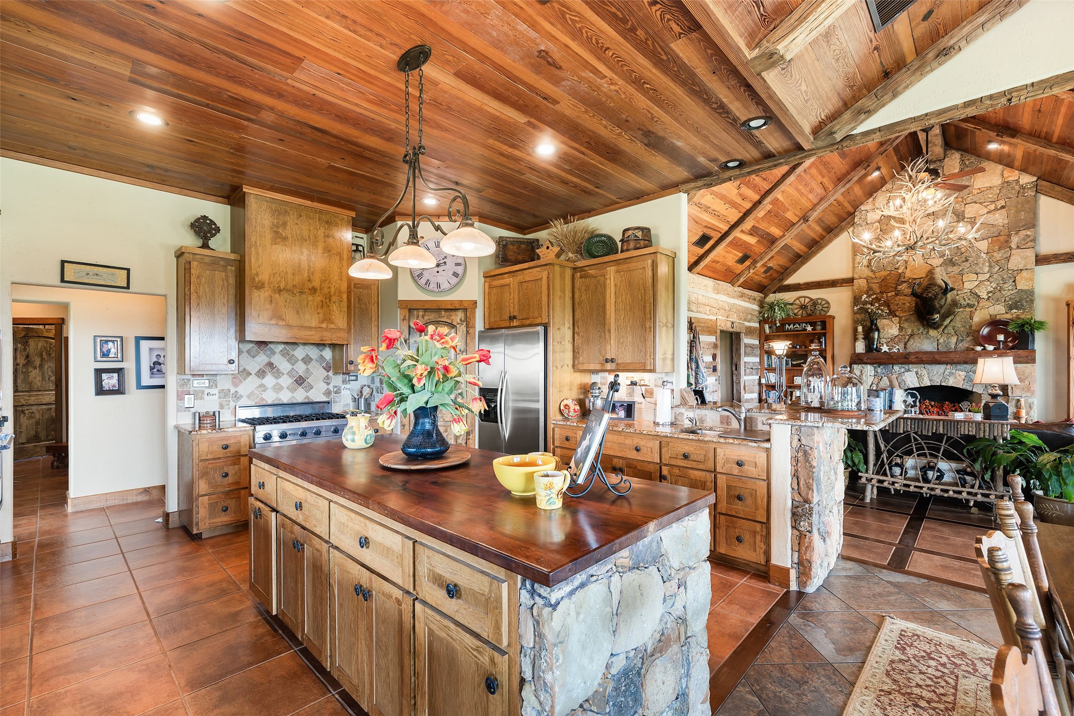 8400 Ranch Road 1431 Marble Falls, TX 78654 - Photo 10 of 30 Experience rustic charm in this kitchen, featuring natural wood ceilings and an inviting stone island.