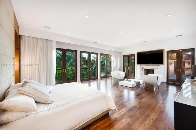 a spacious bathroom with a shower a sink and a large mirror