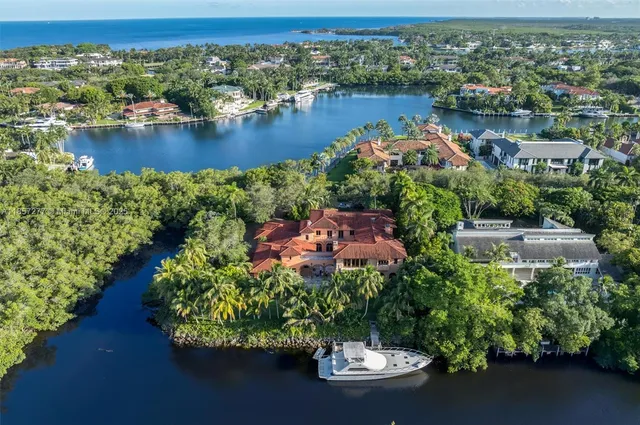an aerial view of a house with a garden and lake view