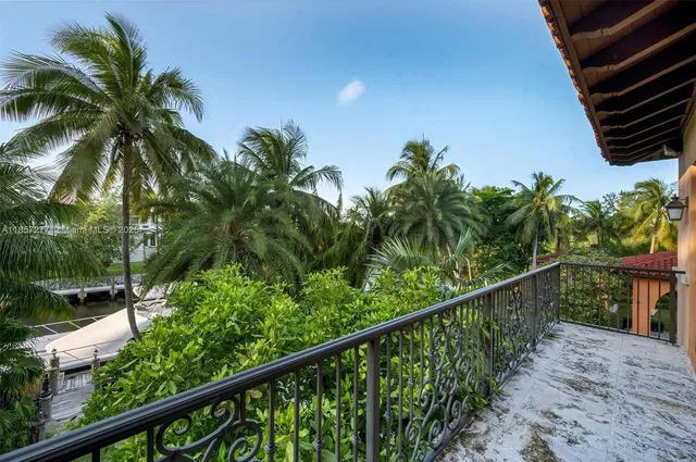 a view of a bathroom with a potted plant and a window