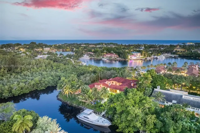 an aerial view of residential house with outdoor space and lake view in back