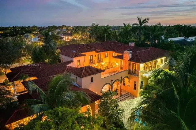 an aerial view of a house with a lake view