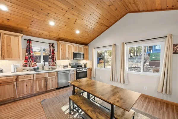a kitchen with stainless steel appliances granite countertop a stove refrigerator and cabinets