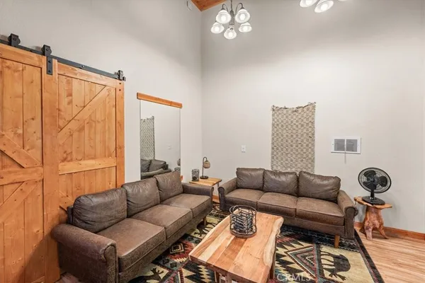 a living room with furniture a rug and a window