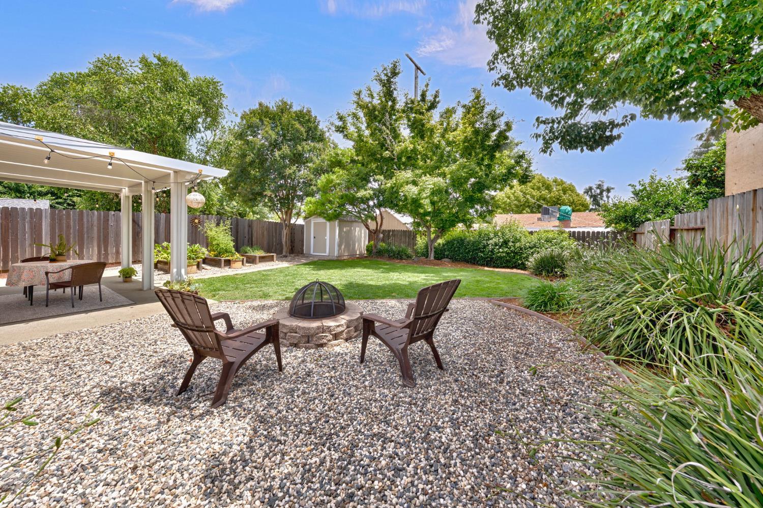 5422 Earnell Street Carmichael, CA 95608 - Photo 39 of 39 a view of a backyard with table and chairs under an umbrella
