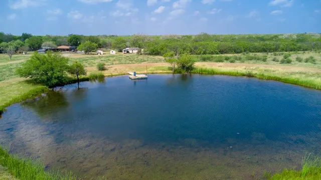 a view of a lake with houses in the back