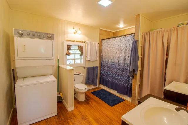 a bathroom with a toilet a sink and shower