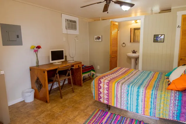 a bedroom with a bed and a table in it