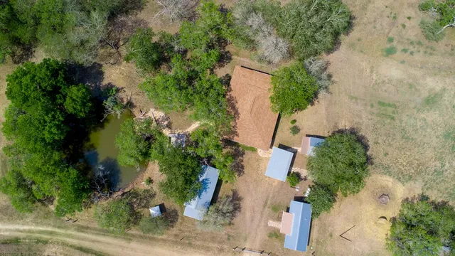 an aerial view of a house with yard