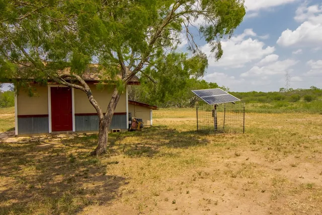 a view of backyard with wooden fence