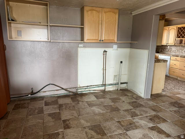 1124 Washam Road Green River, WY 82938 - Photo 18 of 35 Kitchen area featuring square tile flooring, exposed plumbing, and upper cabinetry