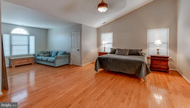 a bedroom with a bed and a lamp