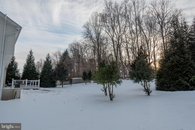 a view of a livingroom with furniture wooden floor kitchen view and living room