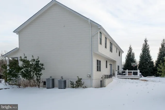 a view of a dining room with furniture a chandelier and wooden floor
