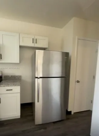 a white refrigerator freezer sitting inside of a kitchen