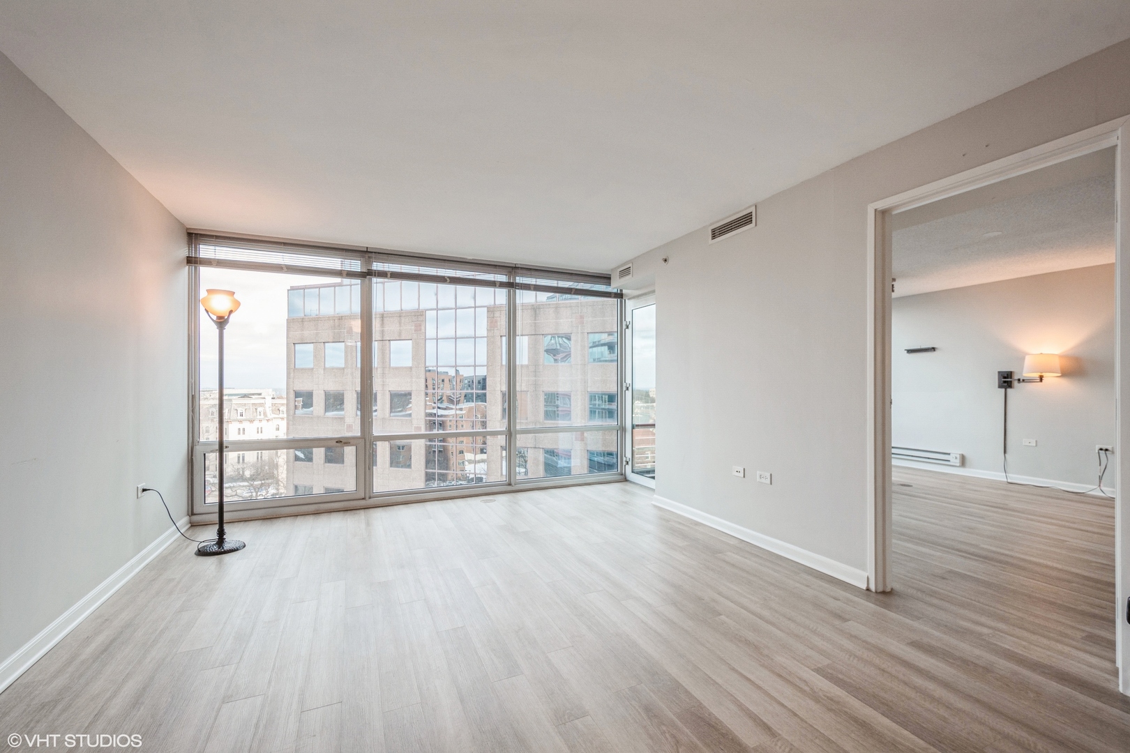 800 Elgin Road, Unit 1013 Evanston, IL 60201 - Photo 3 of 12 a view of an empty room with wooden floor and a window