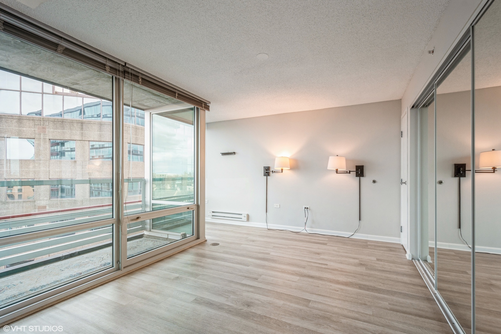 800 Elgin Road, Unit 1013 Evanston, IL 60201 - Photo 4 of 12 a view of empty room with wooden floor and windows