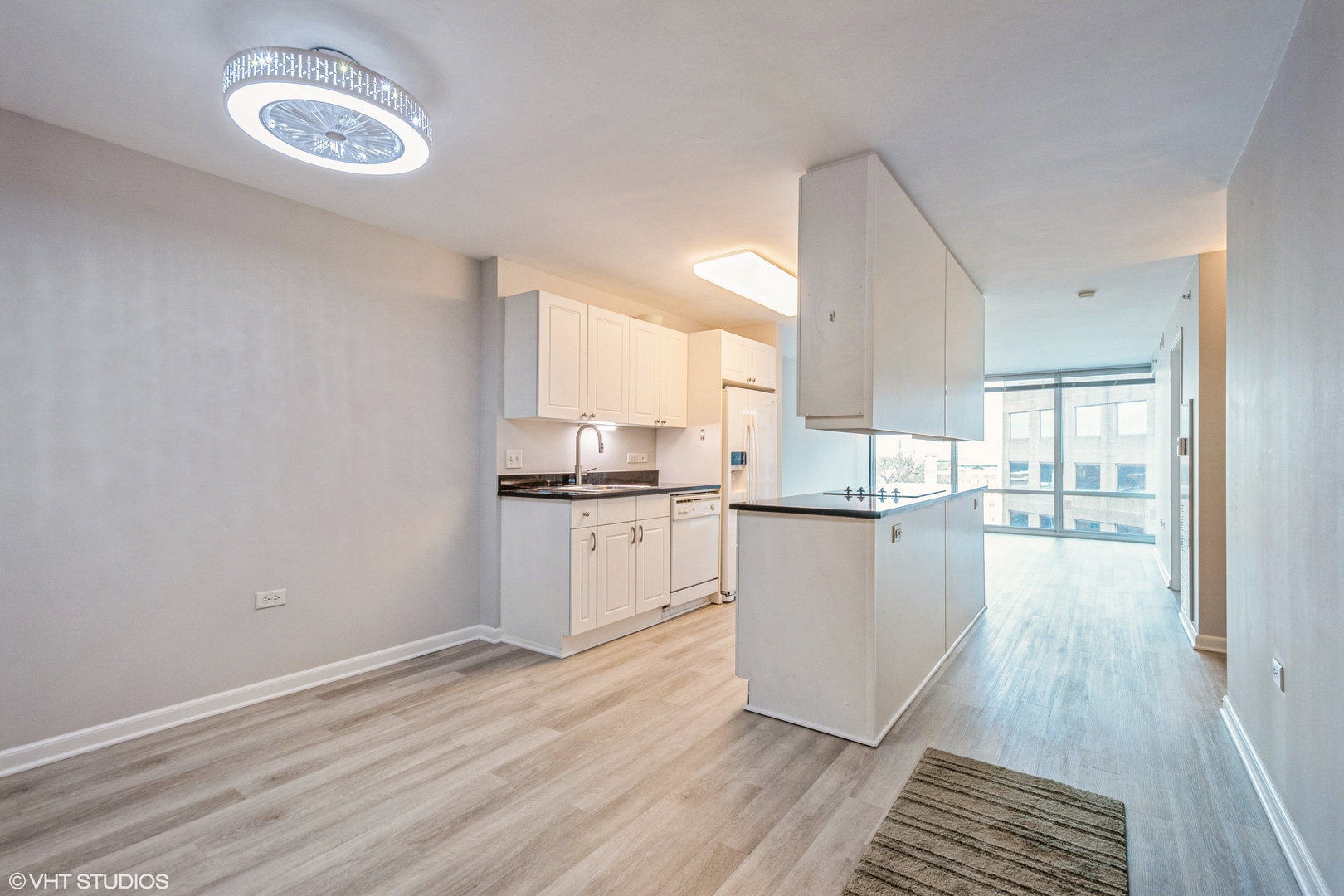 800 Elgin Road, Unit 1013 Evanston, IL 60201 - Photo 8 of 12 a kitchen with wooden floor and window