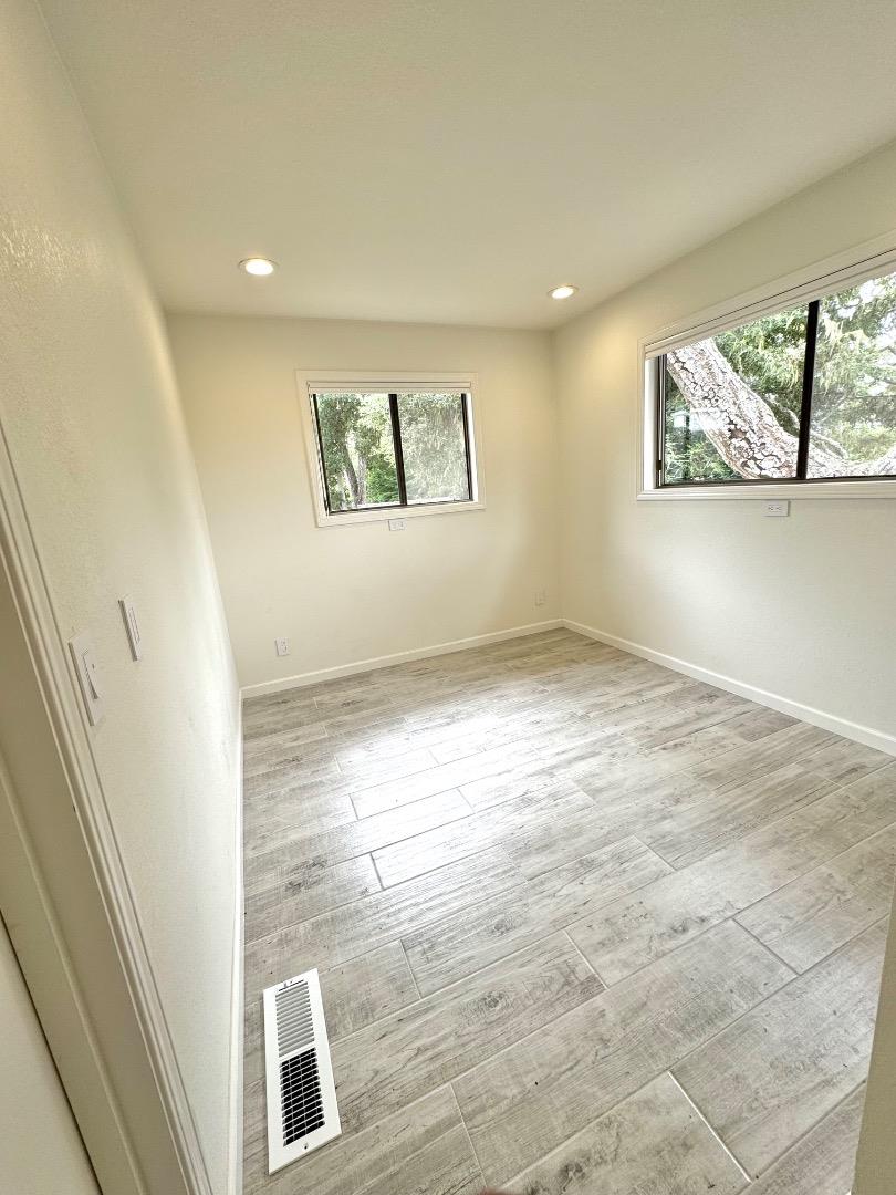 Hermitage Road Pebble Beach, CA 93953 - Photo 2 of 10 an empty room with wooden floor and windows
