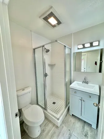 a bathroom with a toilet a sink and shower