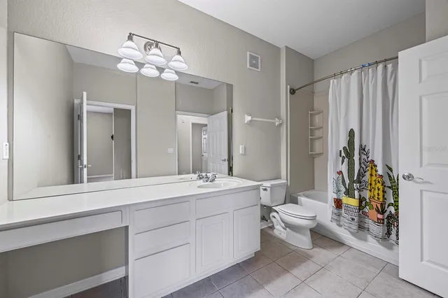 a bathroom with a toilet a sink and a mirror