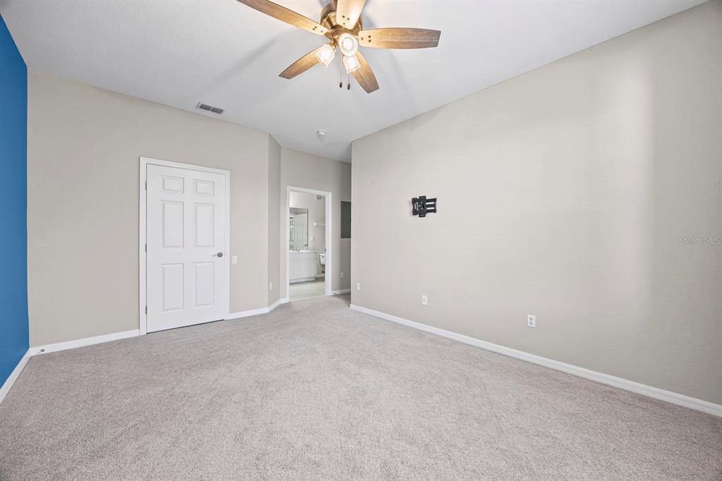 1355 Venezia Court, Unit 405 Davenport, FL 33896 - Photo 14 of 30 a view of an empty room and chandelier fan