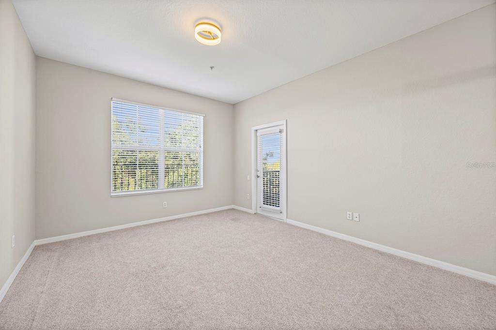 1355 Venezia Court, Unit 405 Davenport, FL 33896 - Photo 5 of 30 an empty room with windows