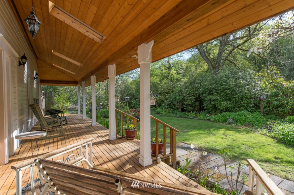 18624 Beall Road Southwest Vashon, WA 98070 - Photo 2 of 25 a view of a patio with table and chairs potted plants with wooden floor and fence